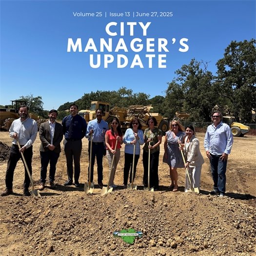 A group of people holding gold shovels, standing behind a pile of dirt at the Saggio Hills Affordable Housing Groundbreaking Event