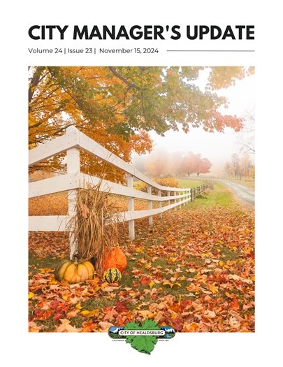 Pumpkins and Fall Leaves in Front of White Fence 