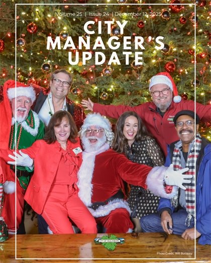 The cover of the Healdsburg City Manager's Update. The City Council sitting on a bench in front of a large Holiday Tree