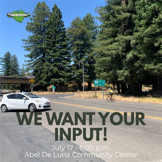 A white car driving on a paved road with a bicyclist passing by 