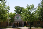 The front entrance of the community center surrounded by trees